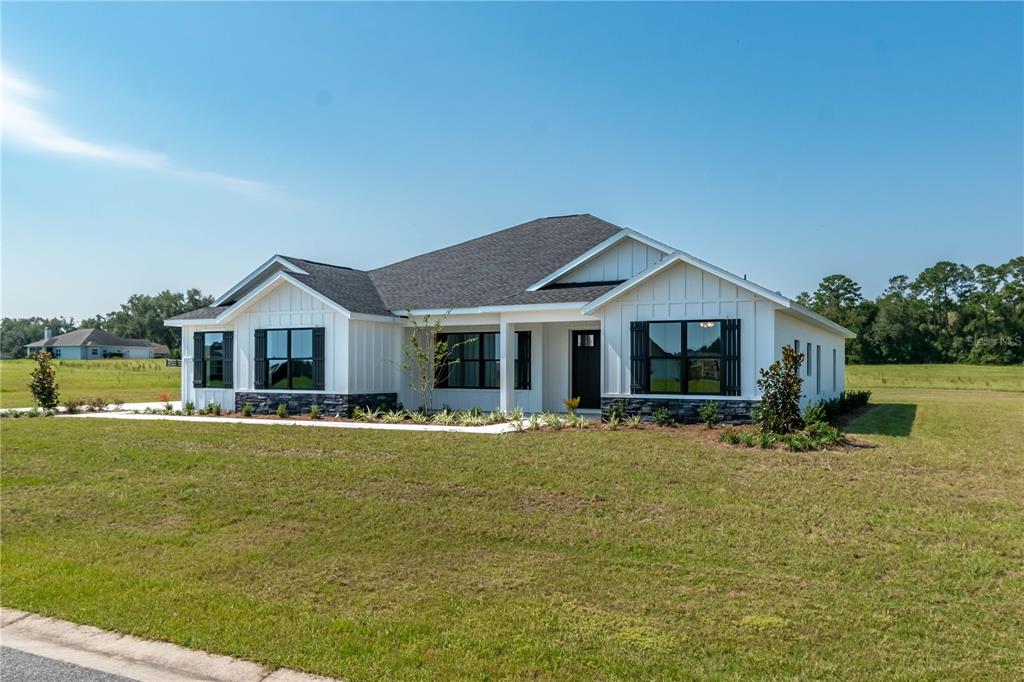 a front view of house with yard and lake view