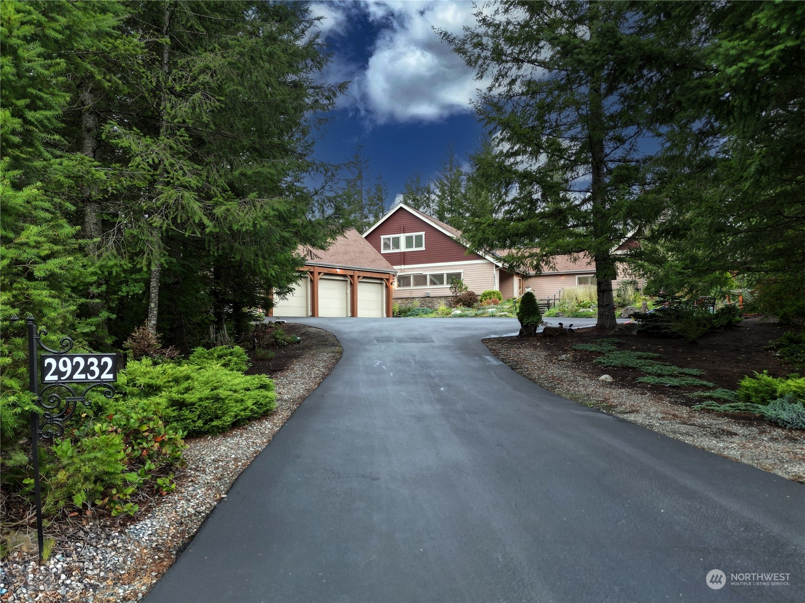 a front view of a house with a yard and green space