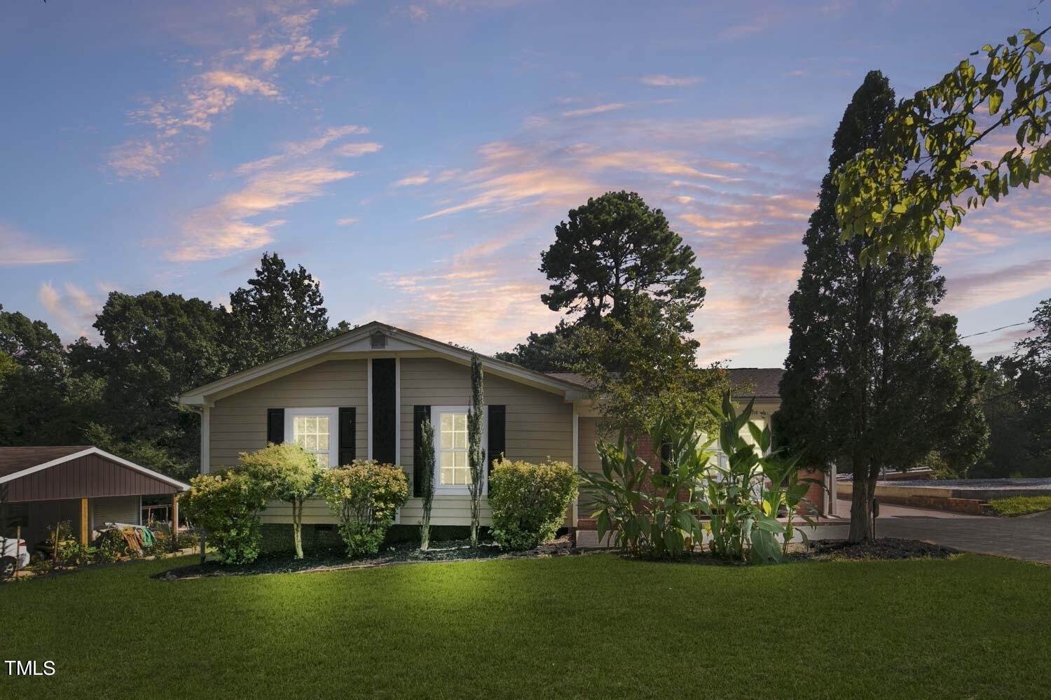 a front view of house with a garden