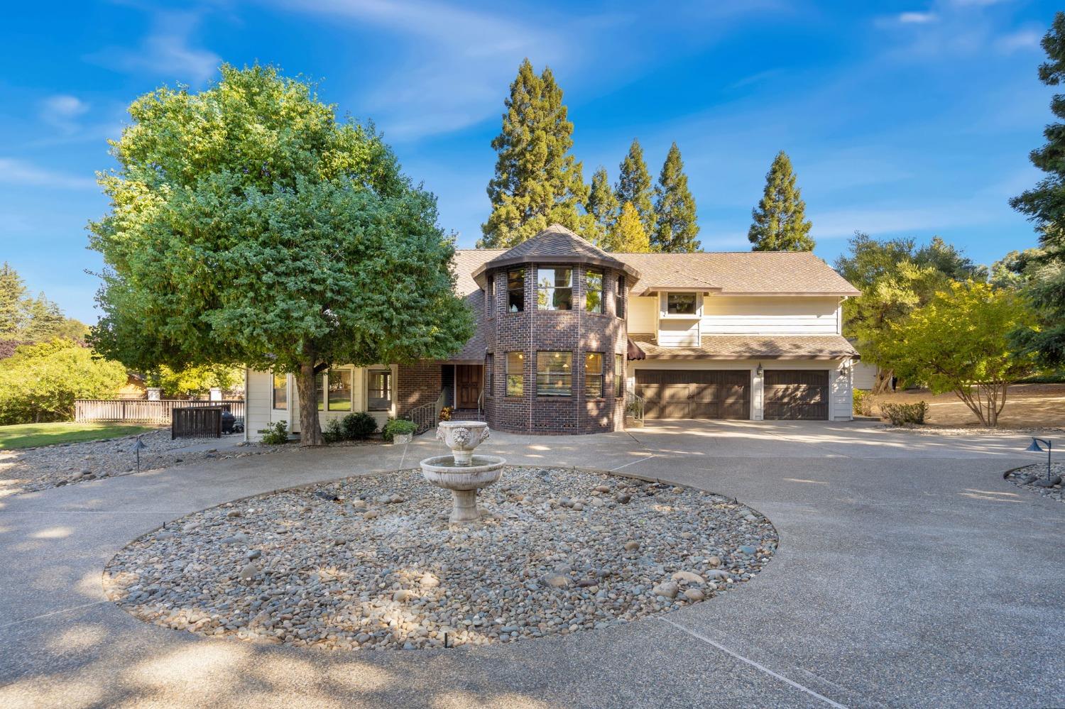 a front view of a house with a yard and trees