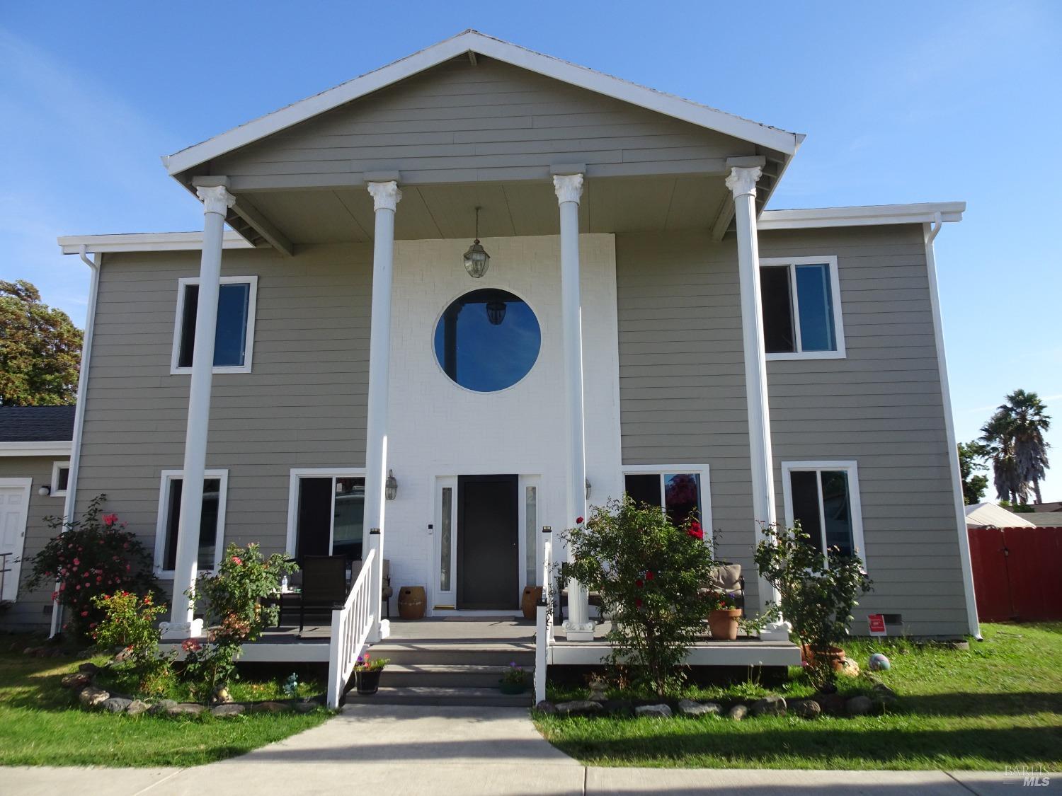 a front view of house with yard and green space