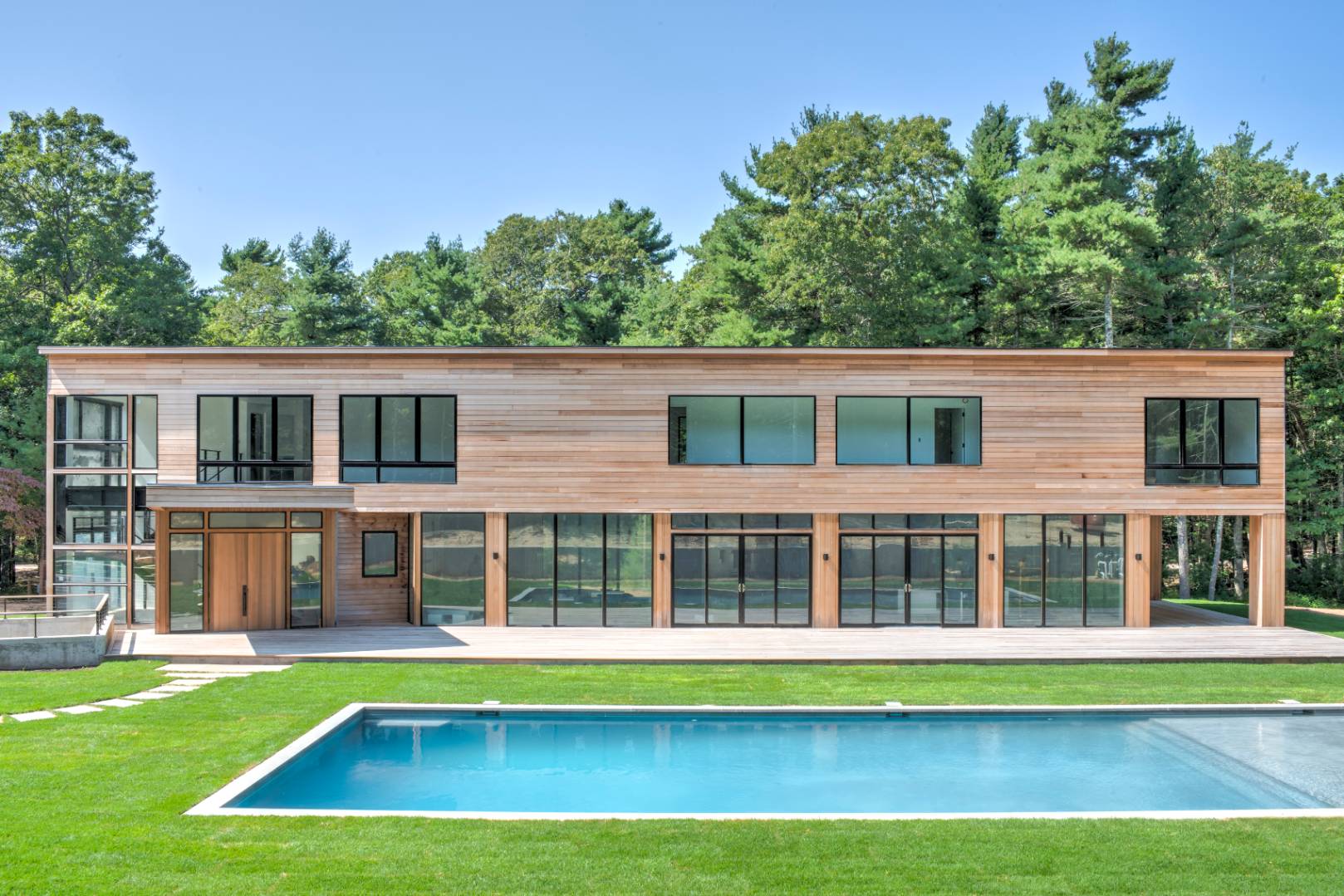 a view of a house with a swimming pool and a yard