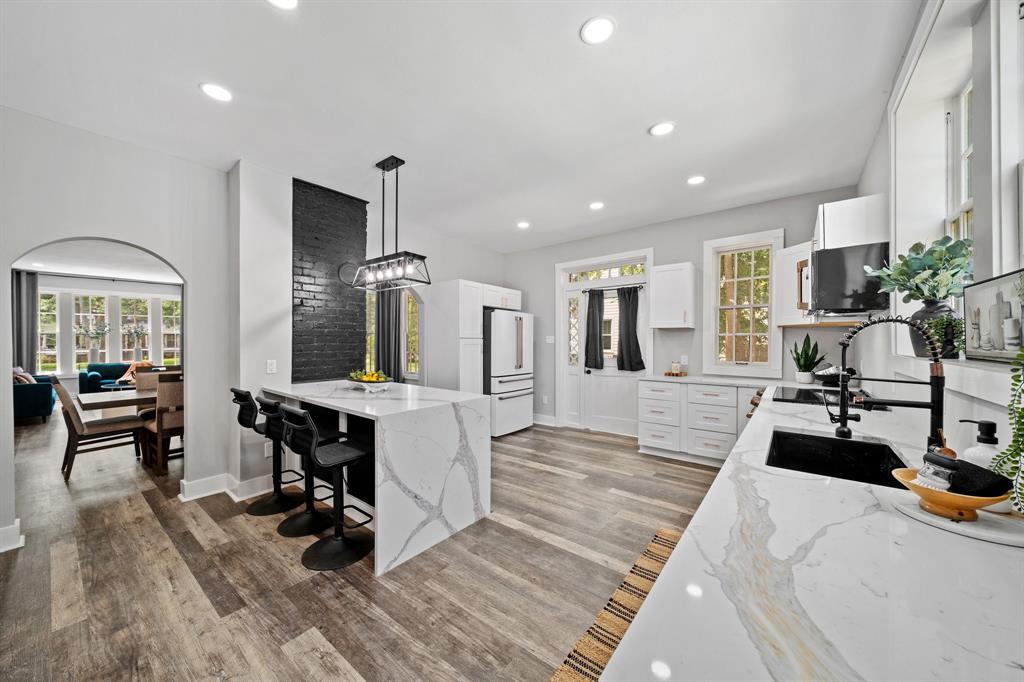 a view of a living room kitchen and a sink