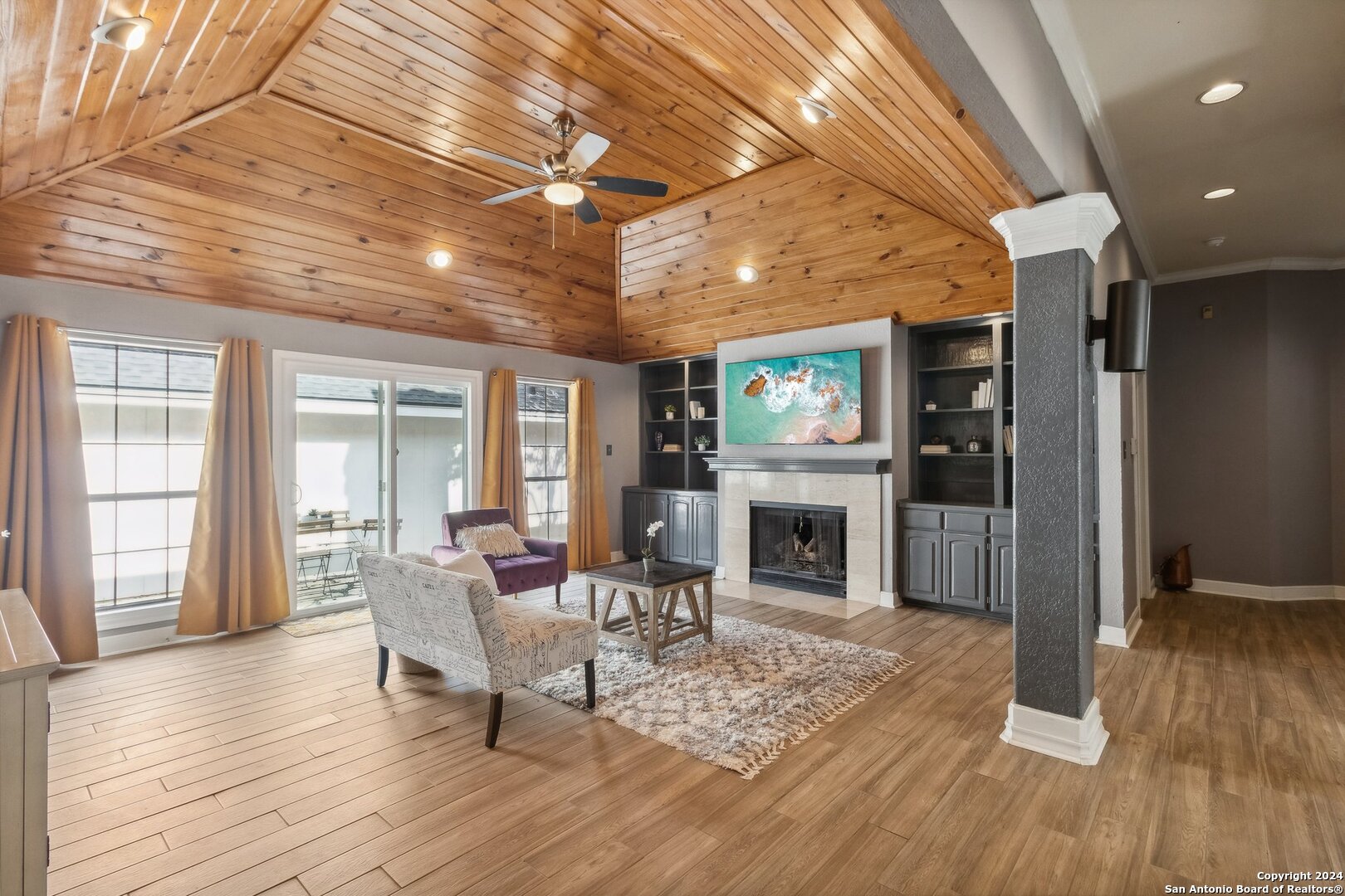 a living room with furniture and a fireplace