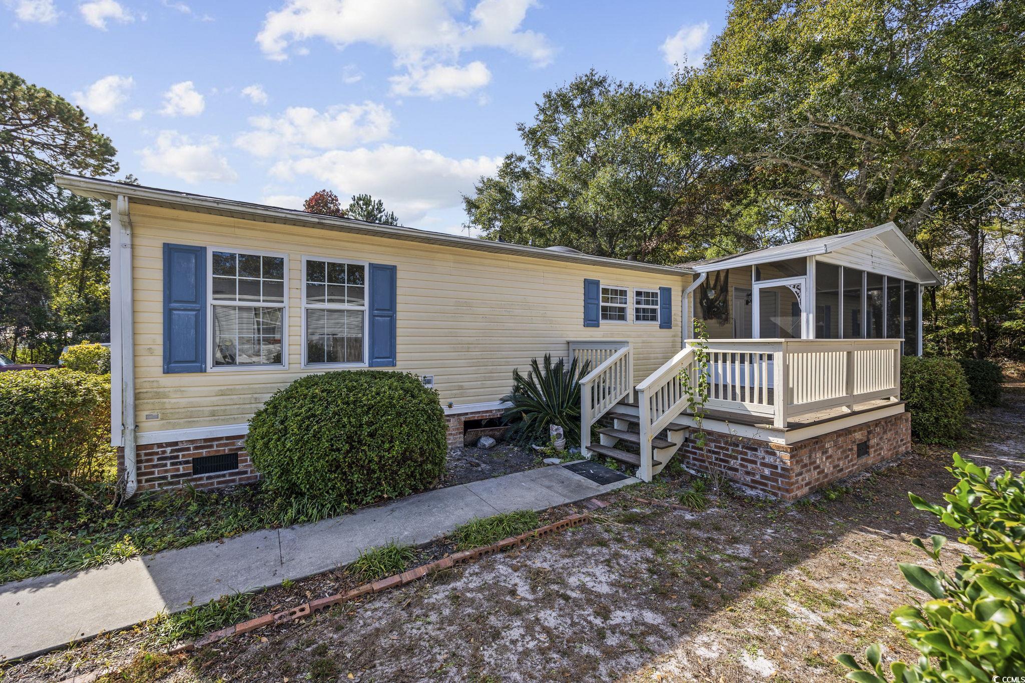 View of front of house with a sunroom