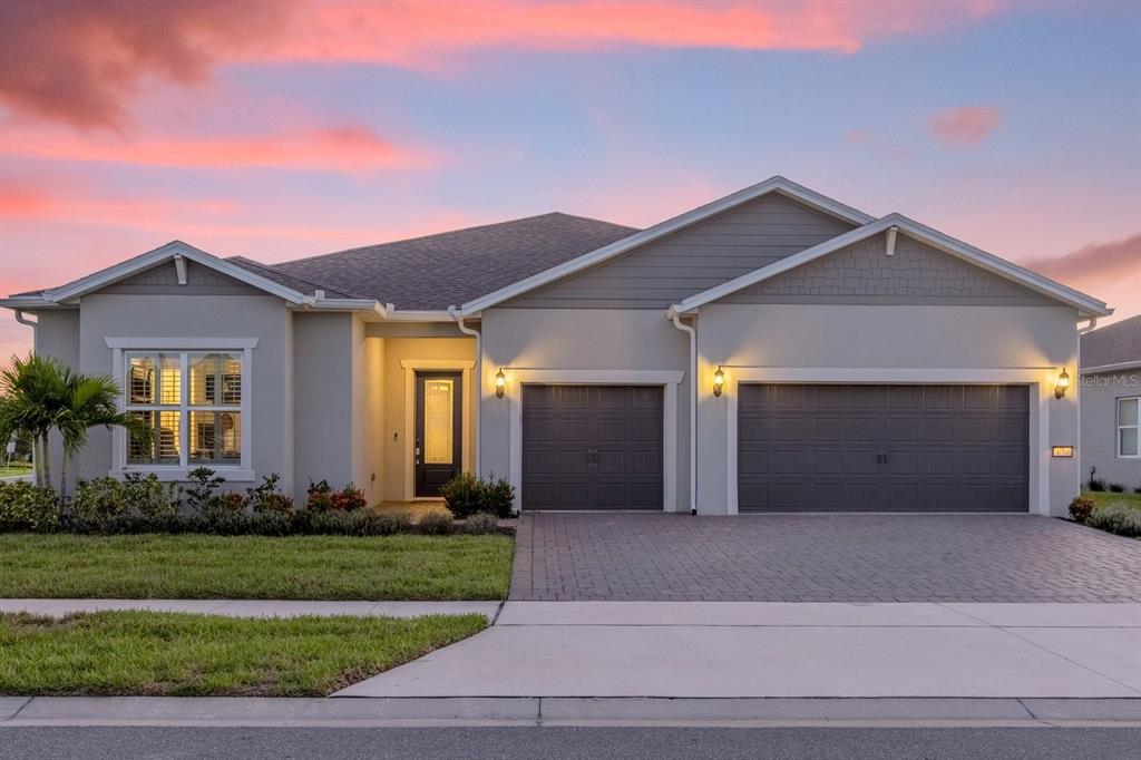 a front view of a house with a yard and garage