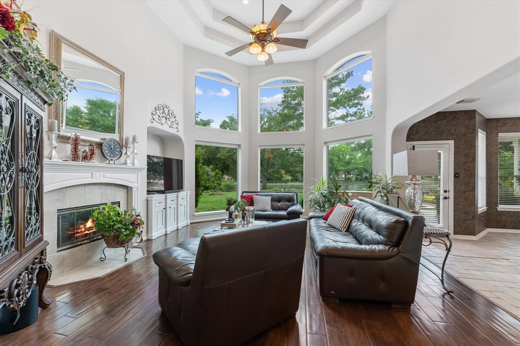 a living room with fireplace furniture and a large window