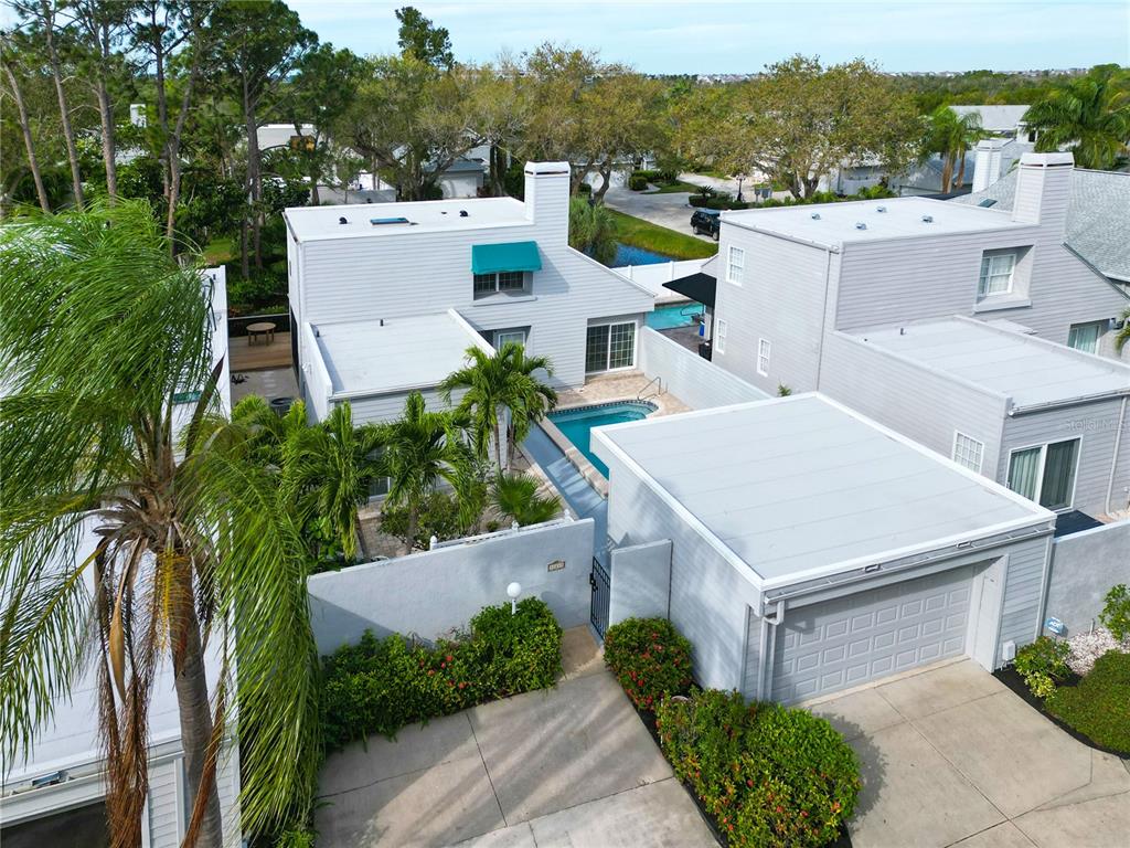 an aerial view of a house with a yard and lake view