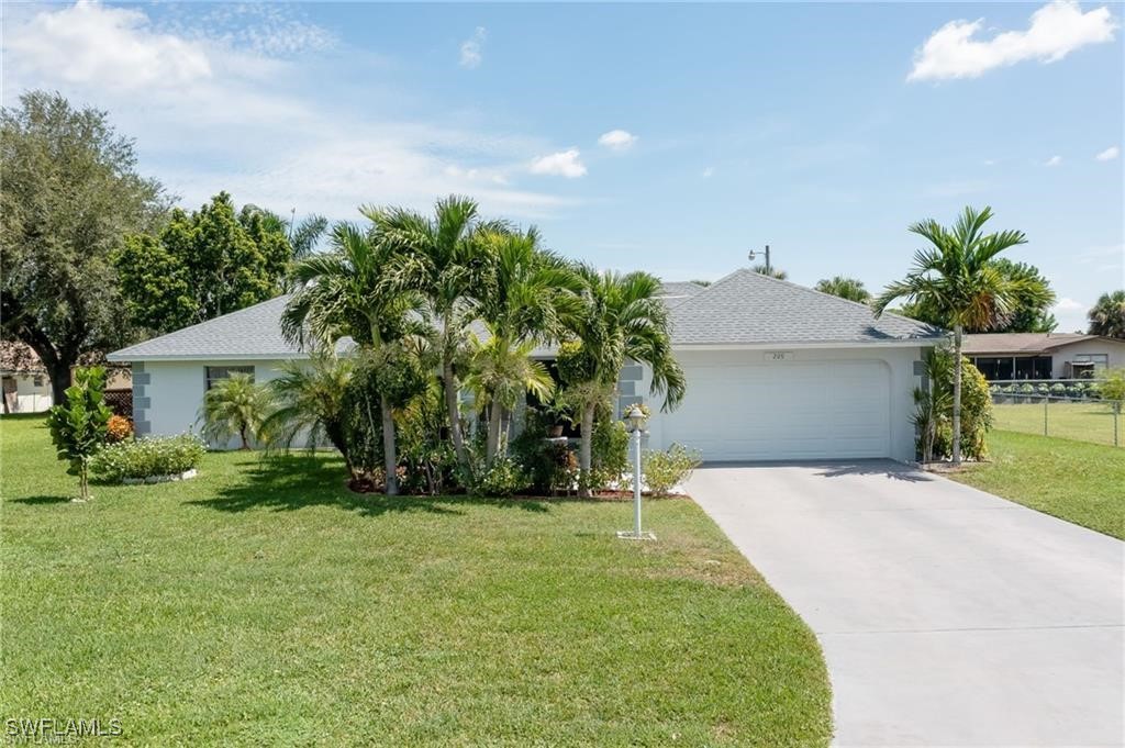 a front view of a house with a yard and garage