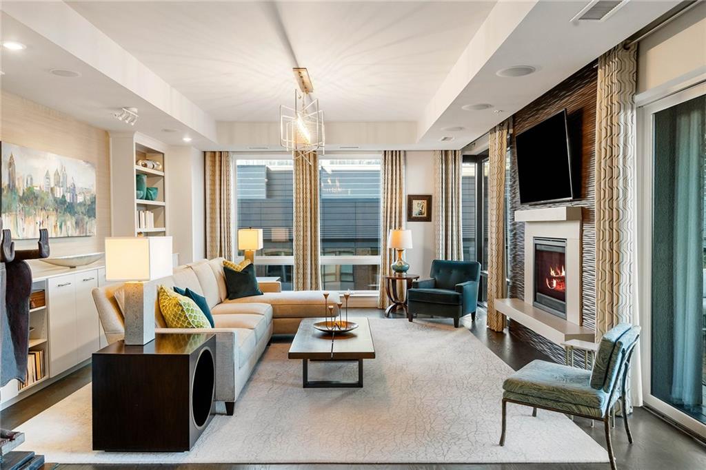 a living room with furniture fireplace and a flat screen tv