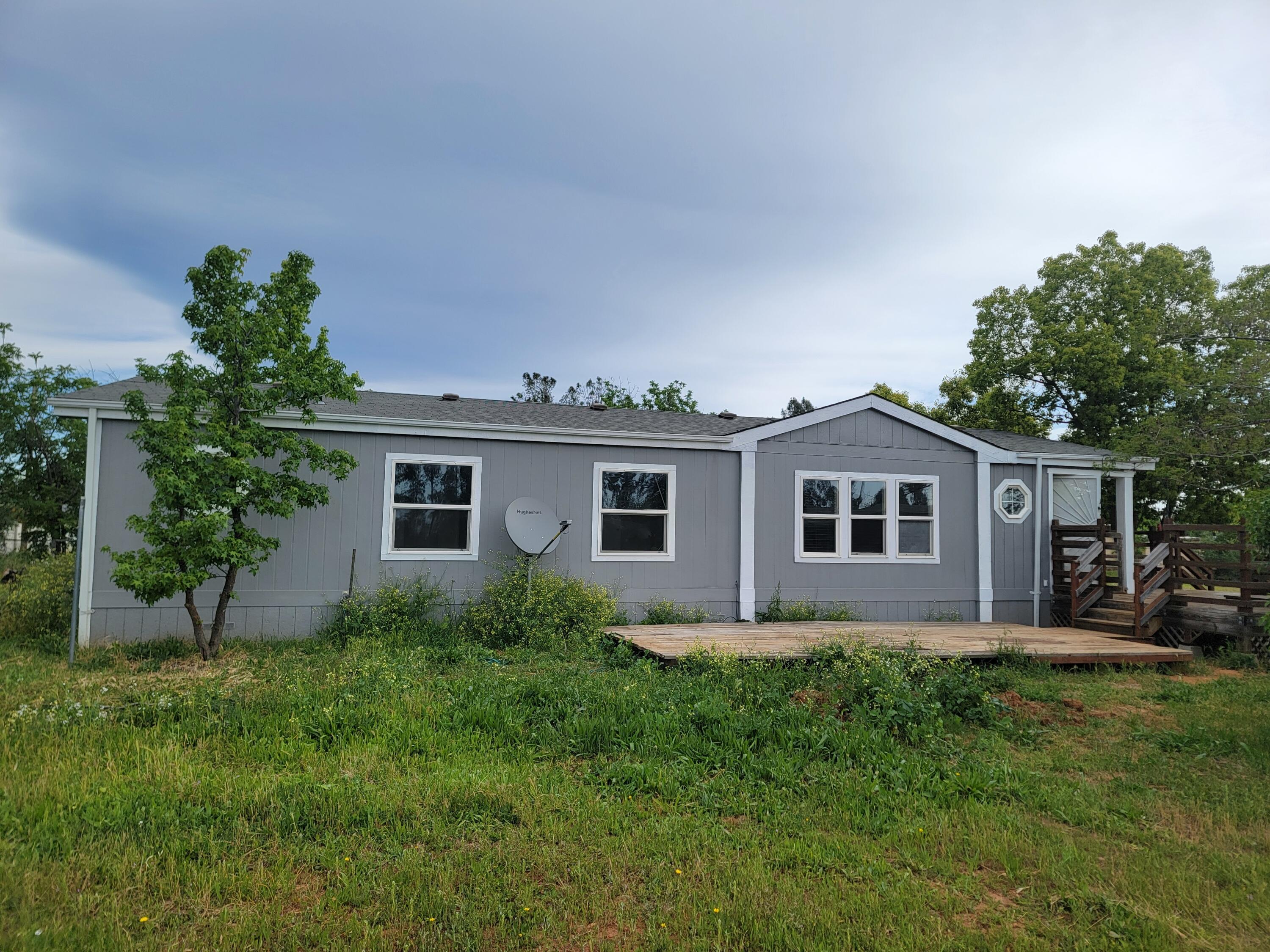 a front view of house with yard and trees