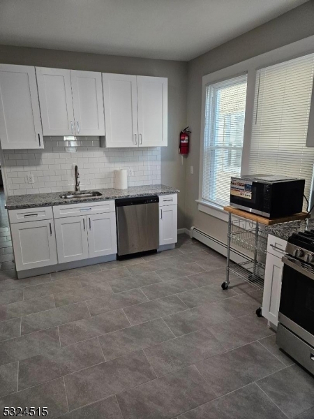 a kitchen with a stove a sink and a microwave