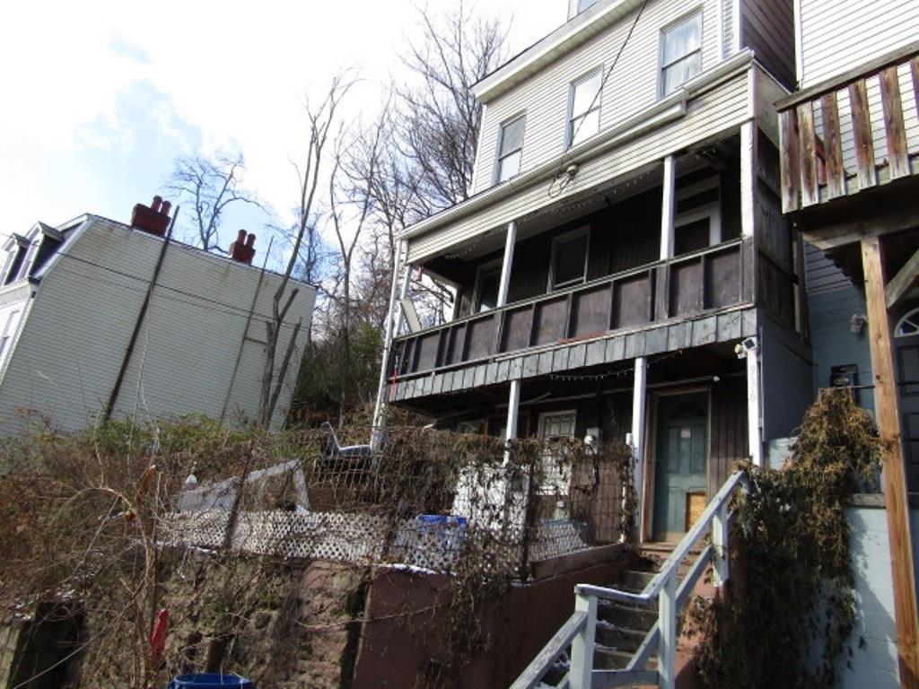 a view of a house with a yard and balcony