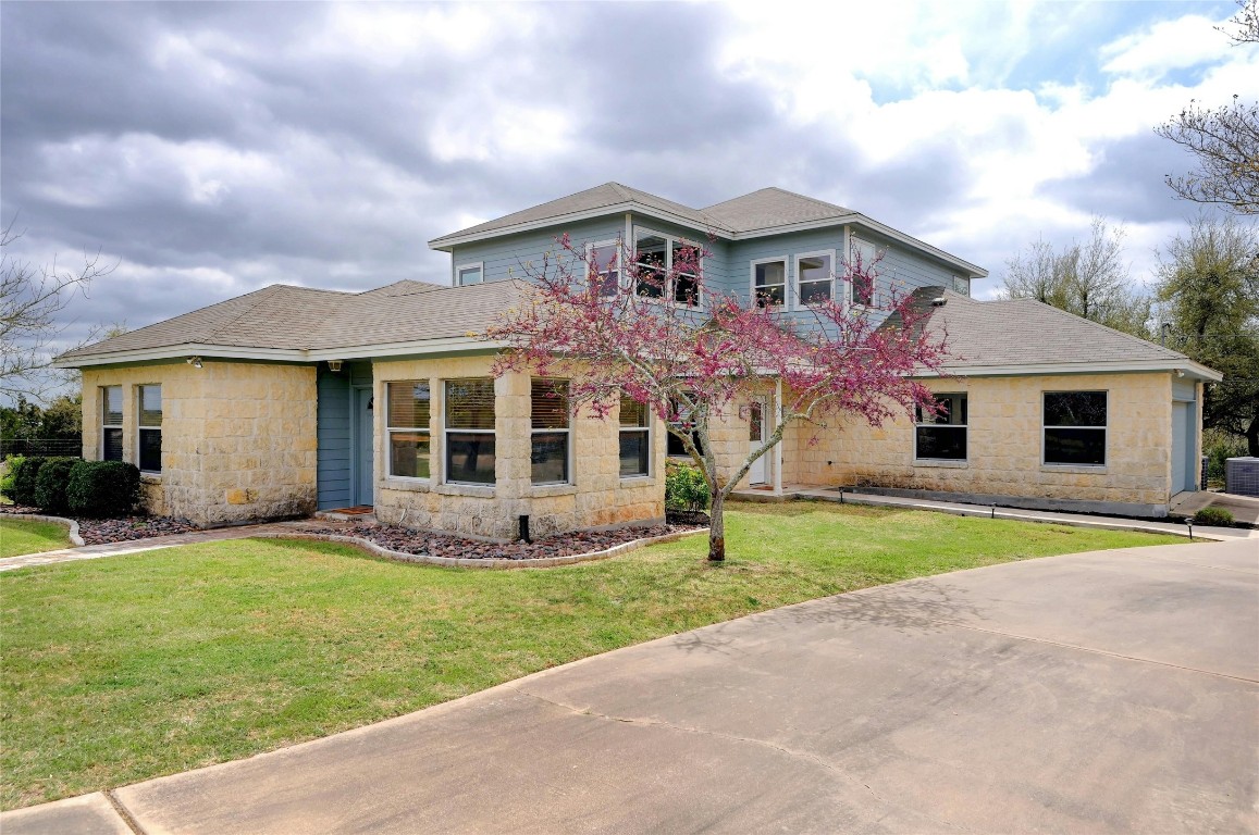 a front view of a house with a yard and porch