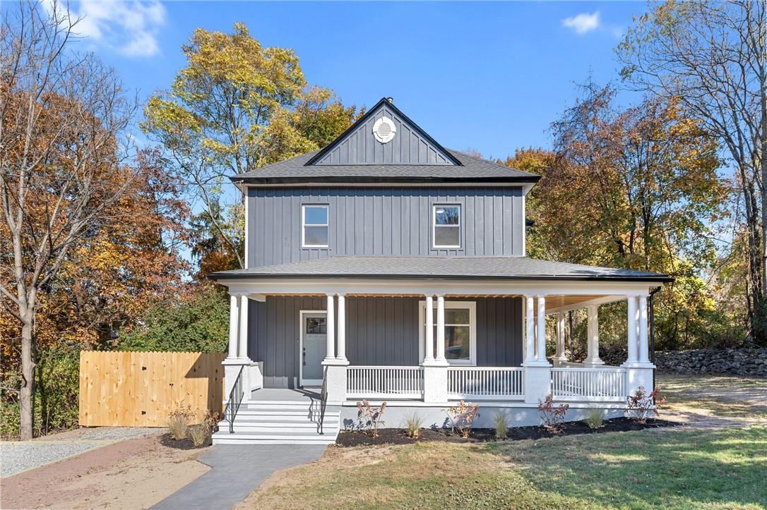 View of front facade with a porch and a front yard