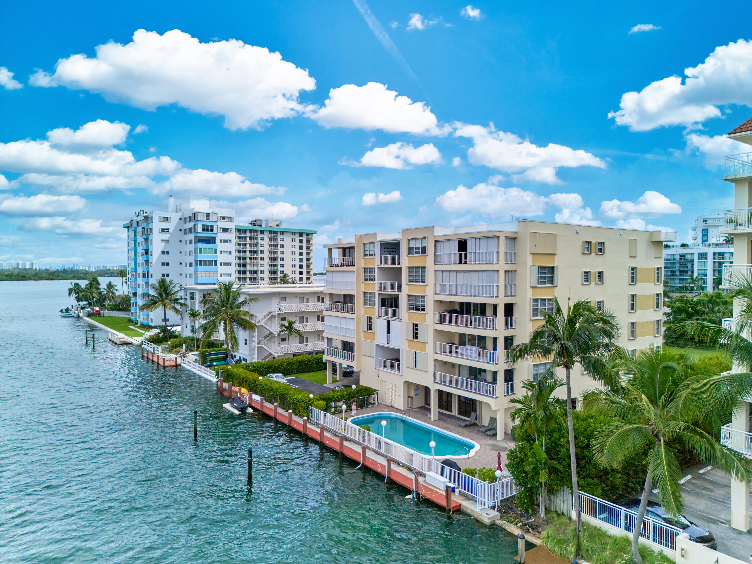 a view of a multi story residential apartment building with a yard