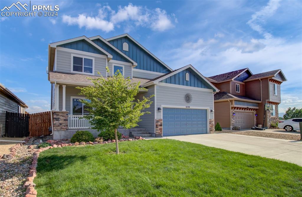 Craftsman-style home featuring a porch and a front yard