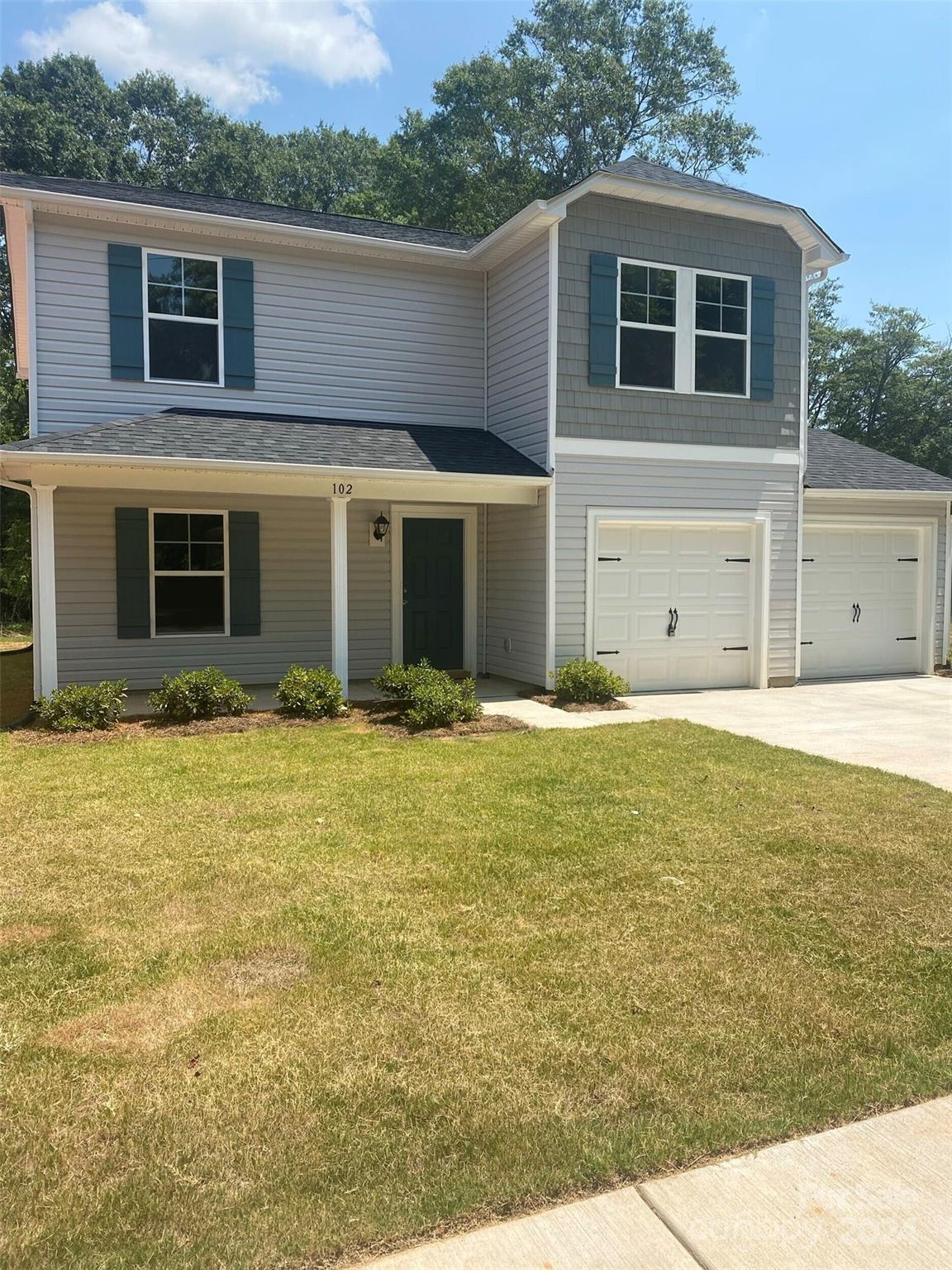 a front view of a house with garage