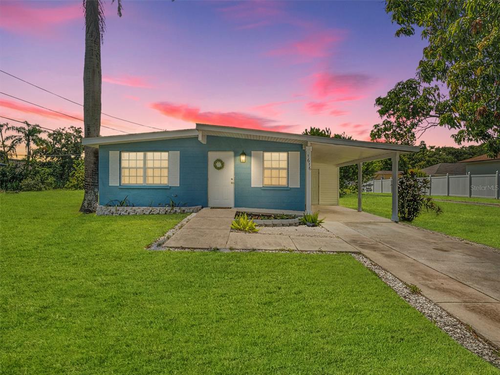 a view of a house next to a yard