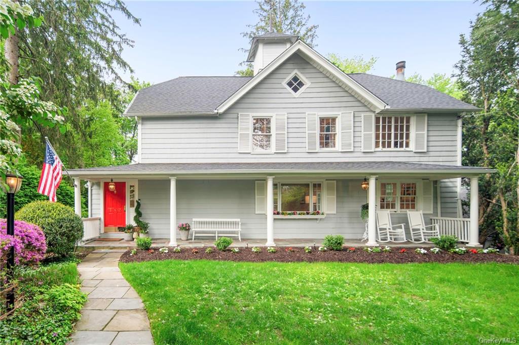 a front view of a house with swing and plants