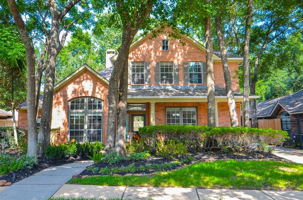 Mature trees shade the entry with lush foliage welcoming you to the home.