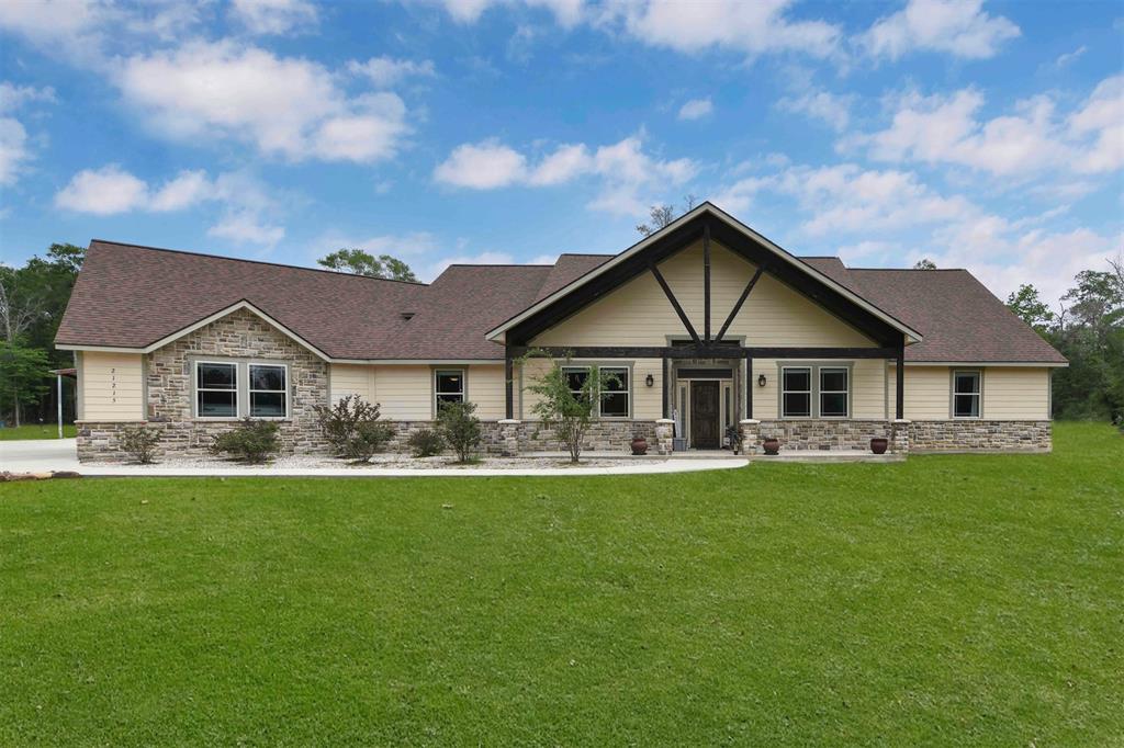 a front view of a house with a garden