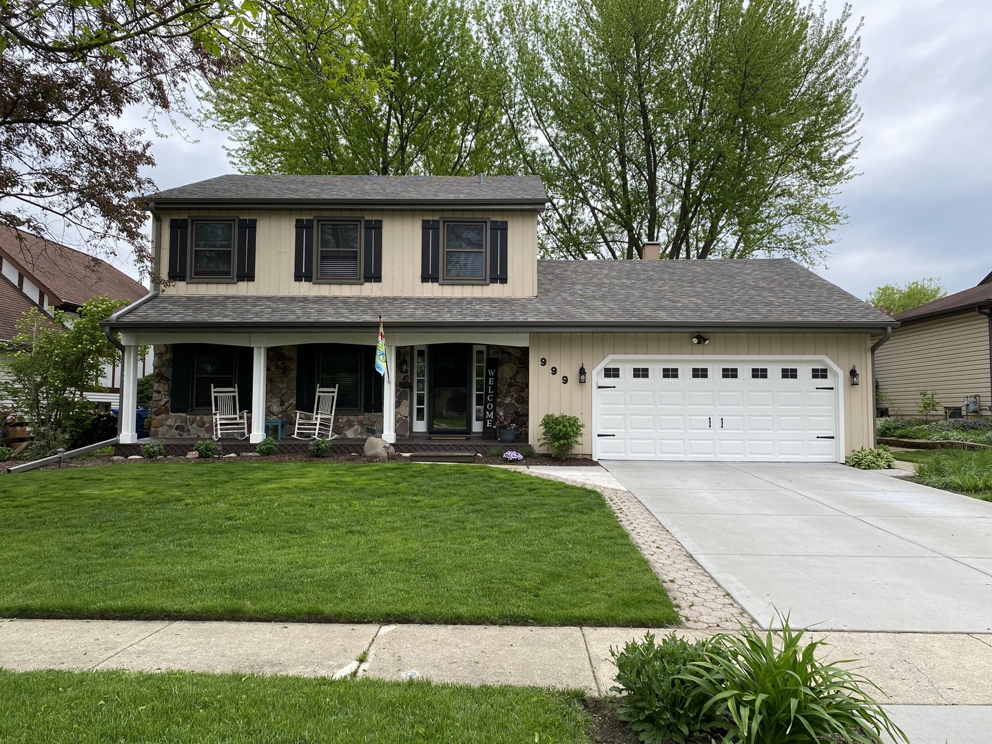 a front view of a house with a garden