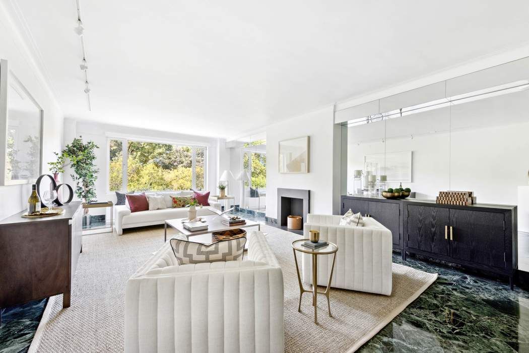 a living room with furniture fireplace and a table