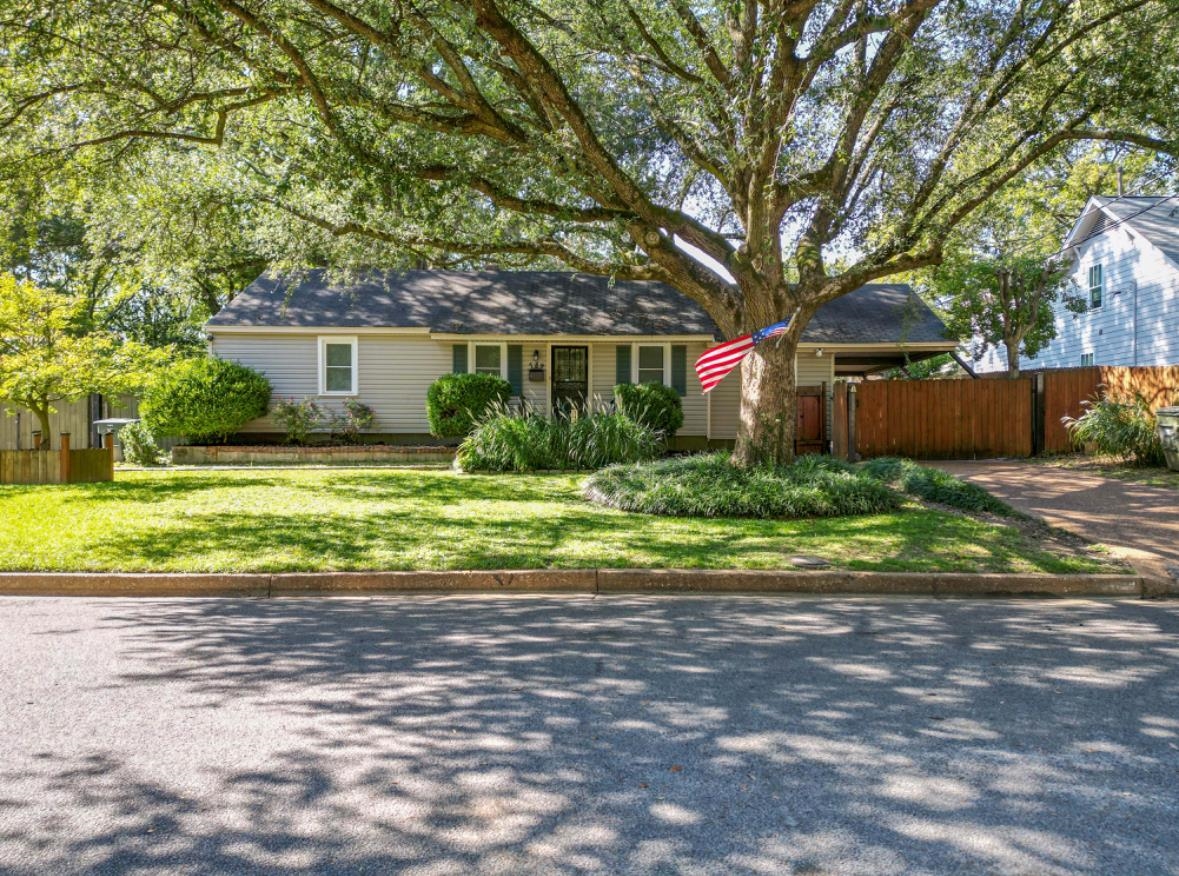 a front view of a house with a yard and a garage