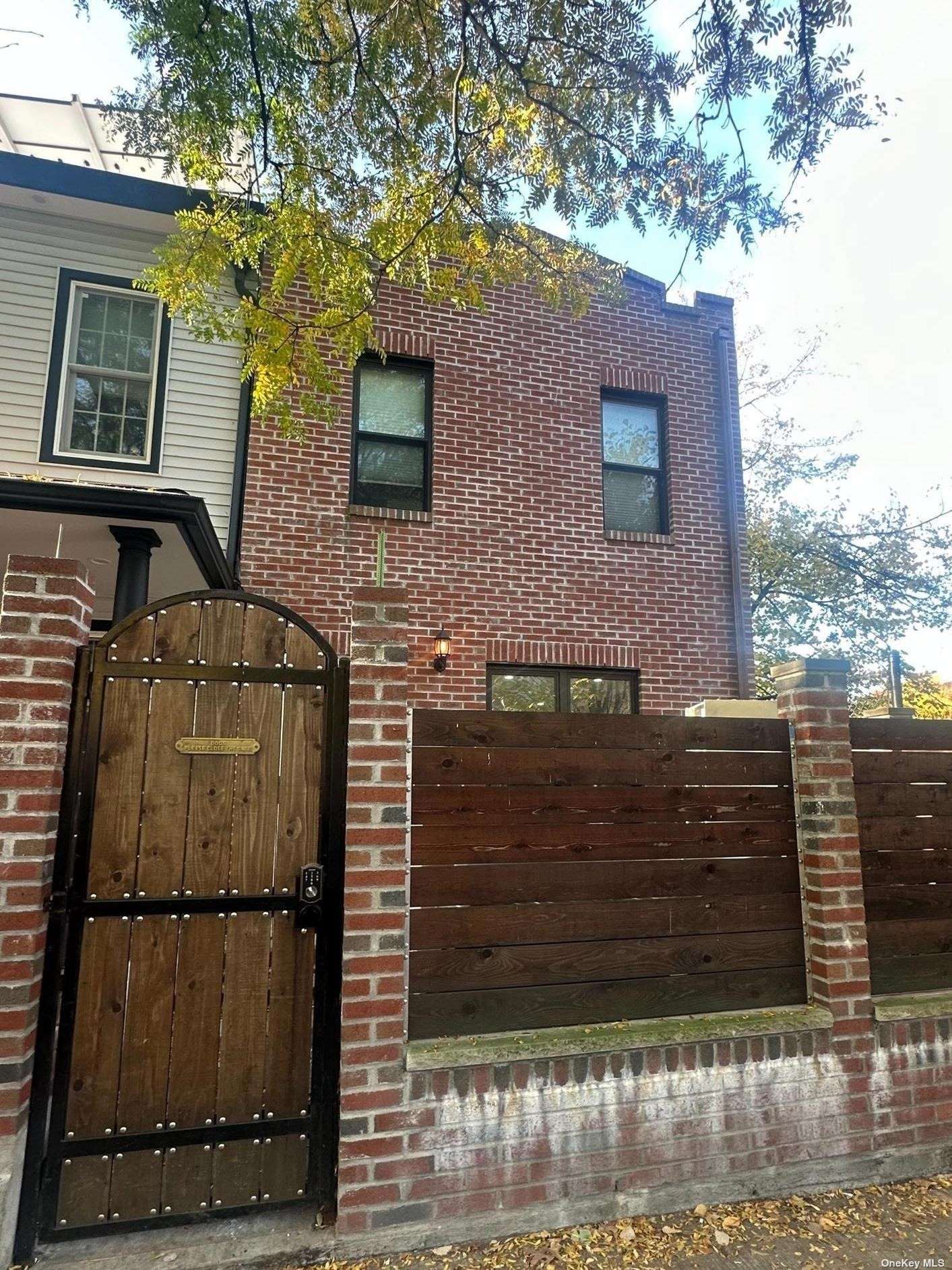 a view of a brick house with many windows