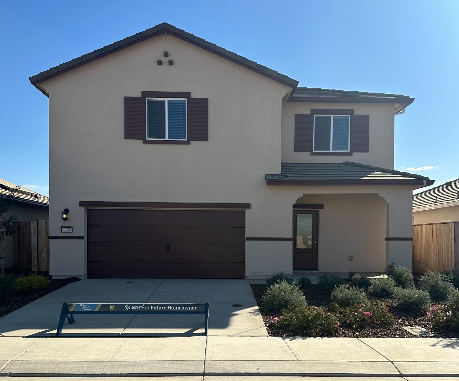 a front view of a house with garage