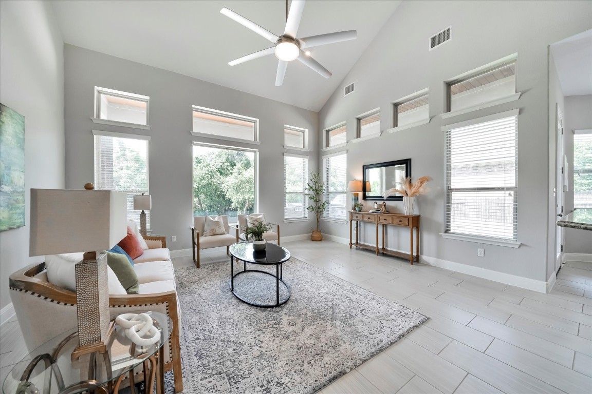 a living room with furniture and floor to ceiling windows