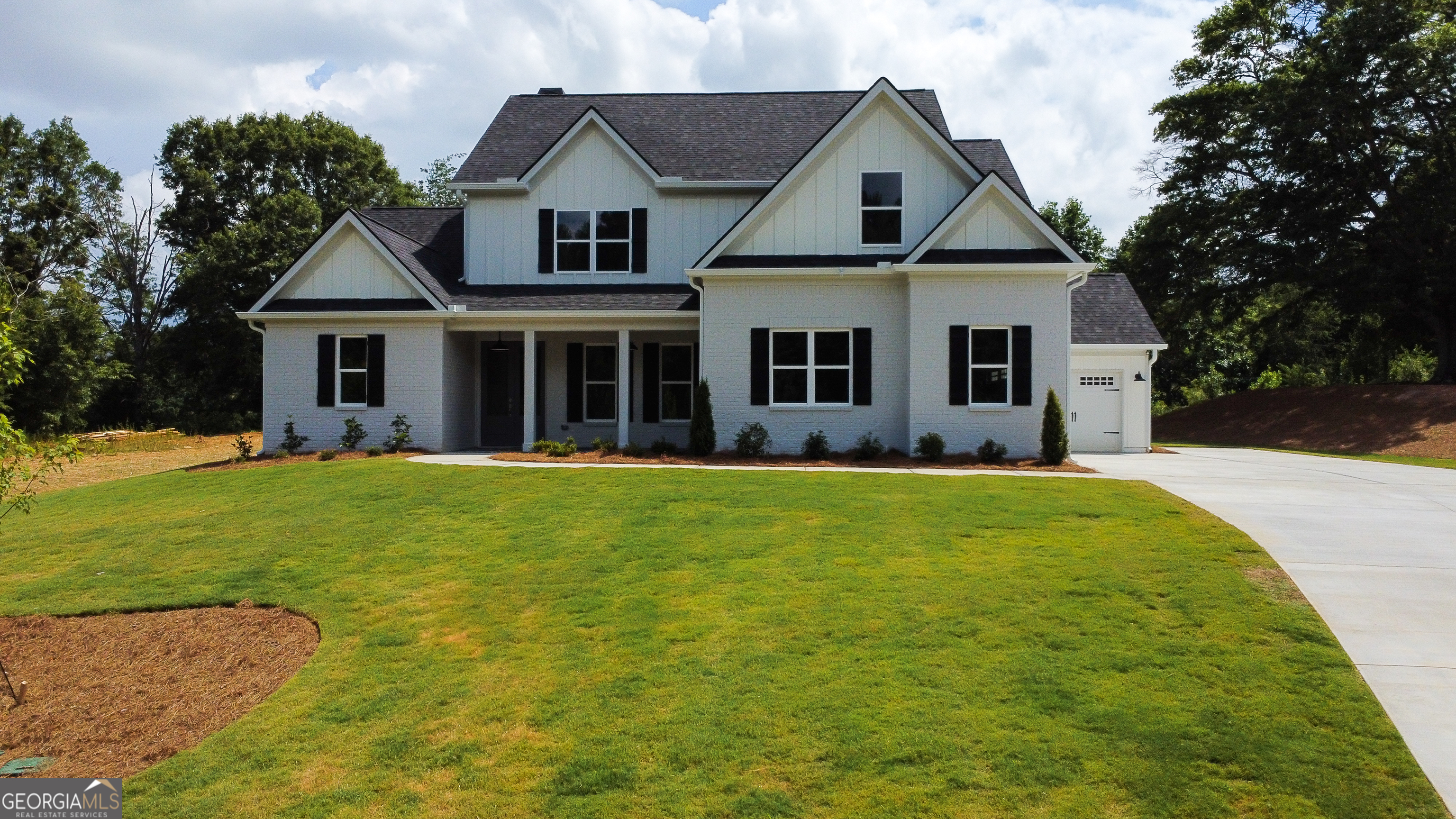 a front view of house with yard and green space