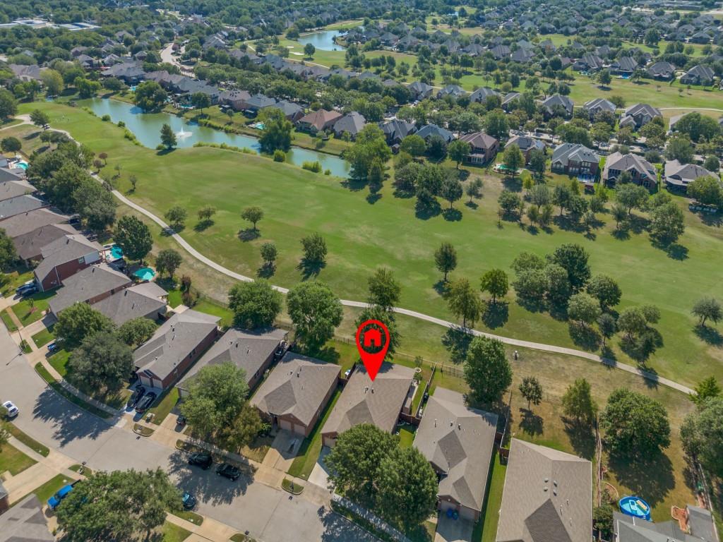 an aerial view of residential houses with outdoor space and street view