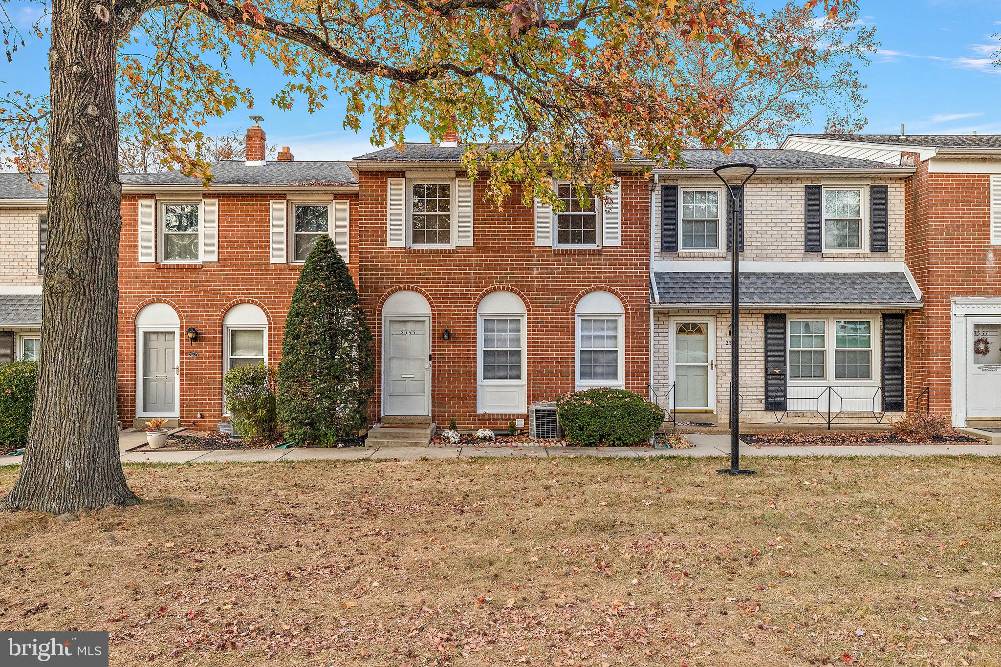 front view of brick house with a yard