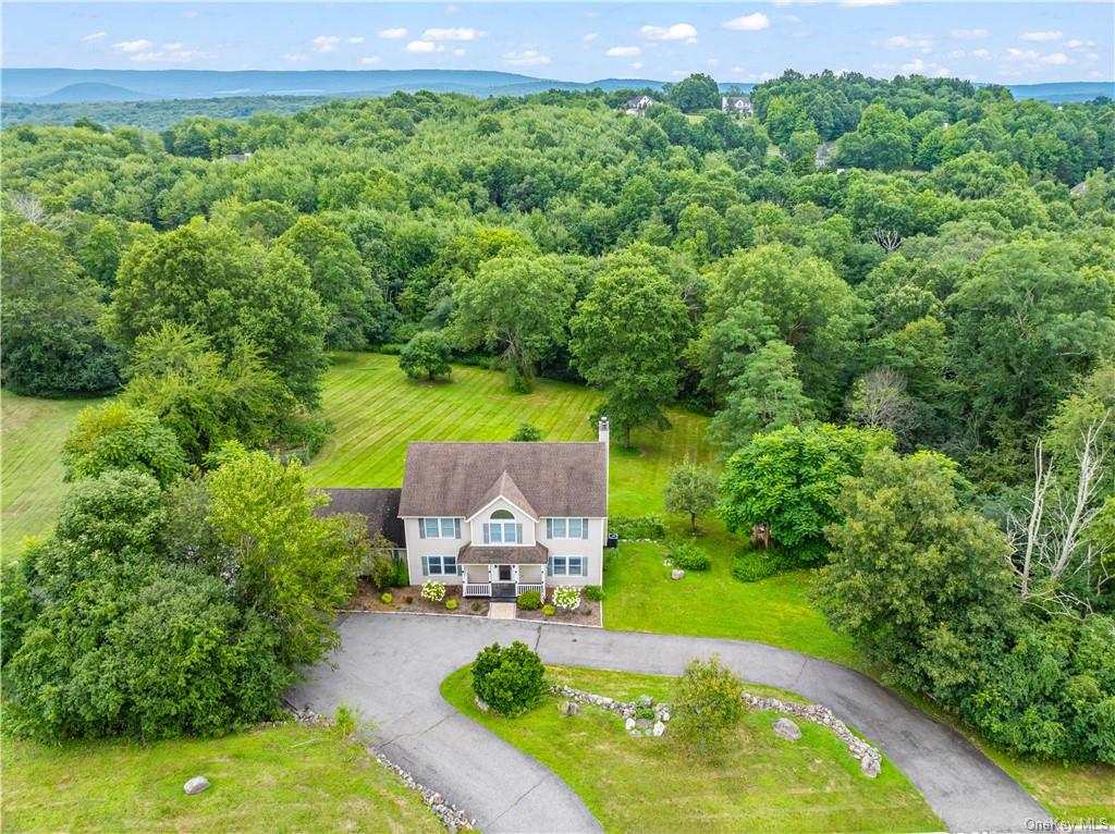 an aerial view of a house with a yard