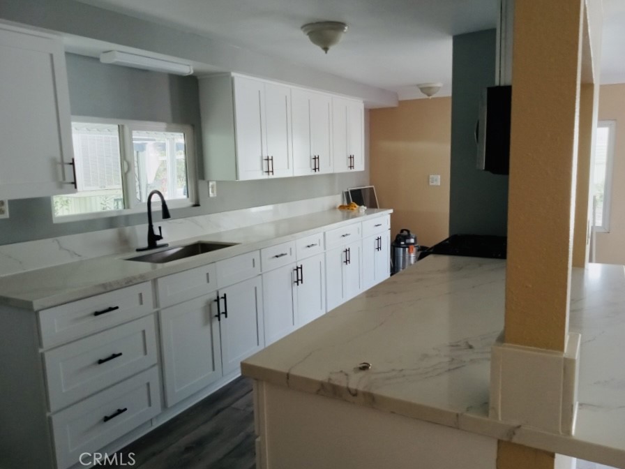 a kitchen with cabinets appliances and a window