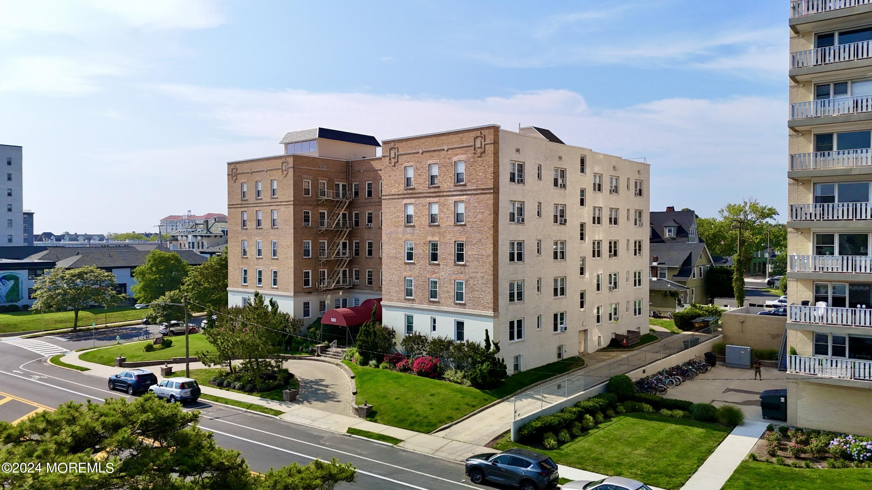 a view of a tall building and a yard