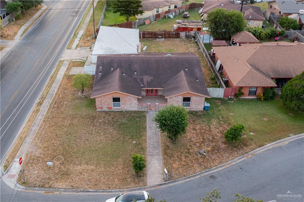 an aerial view of a house with garden space and street view