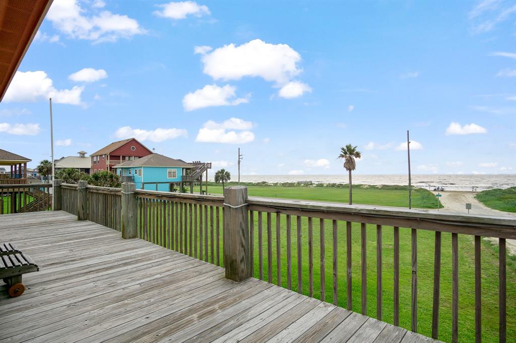 a view of a deck with wooden floor and lake view