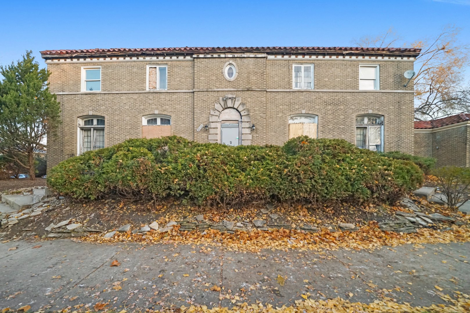 a front view of a house with a garden