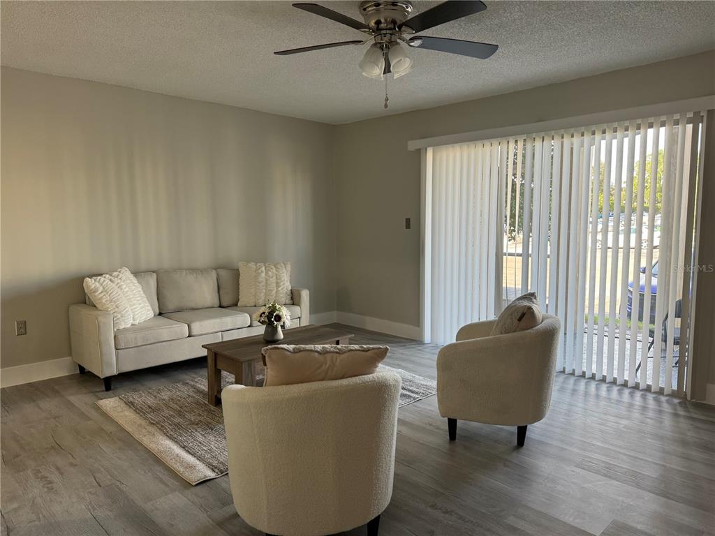 a living room with furniture and a potted plant