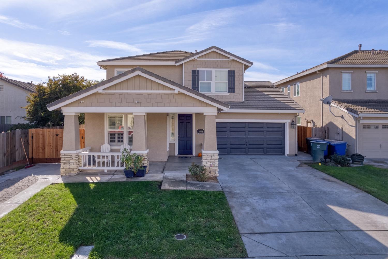 a front view of a house with a yard and outdoor seating