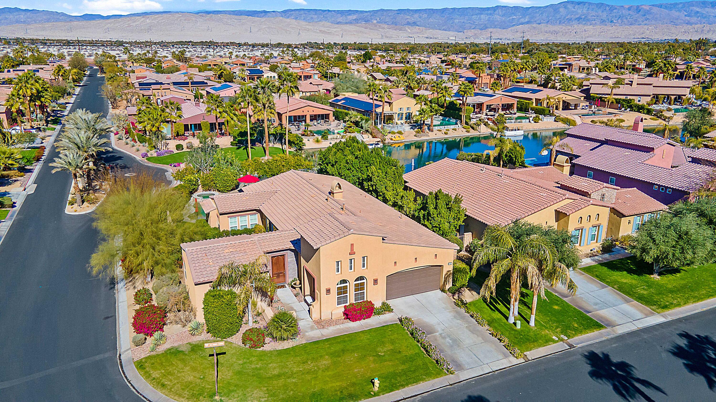 an aerial view of residential houses with outdoor space and swimming pool