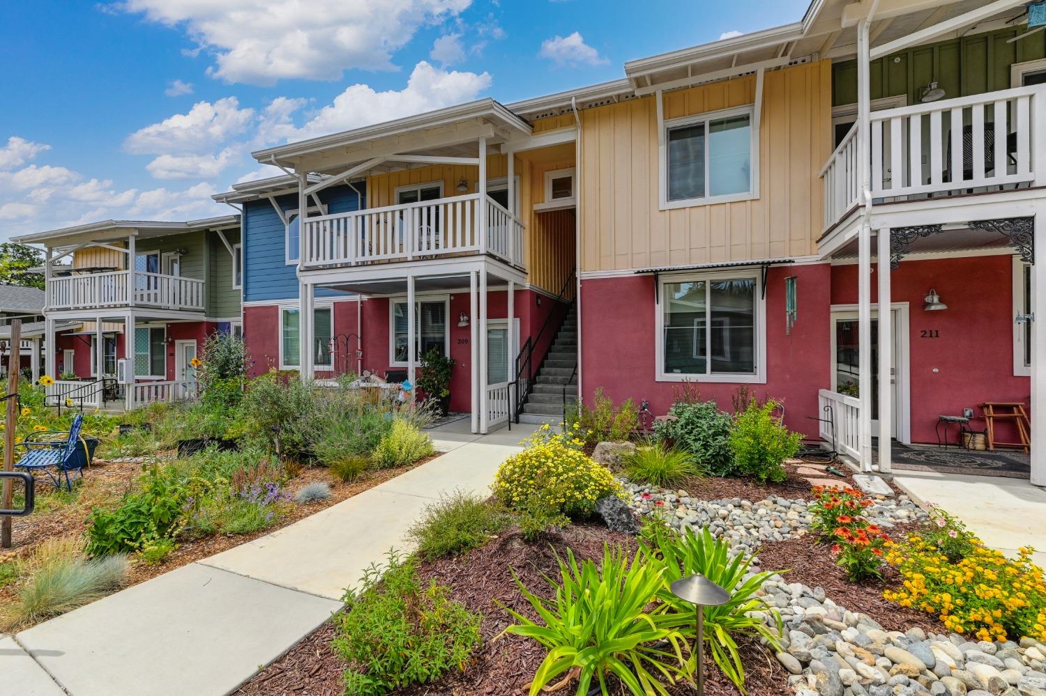 Front view of the flat that highlights the balcony and drought tolerant landscaping.