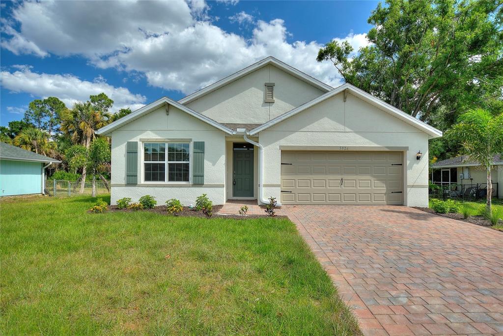 a front view of a house with a yard and garage