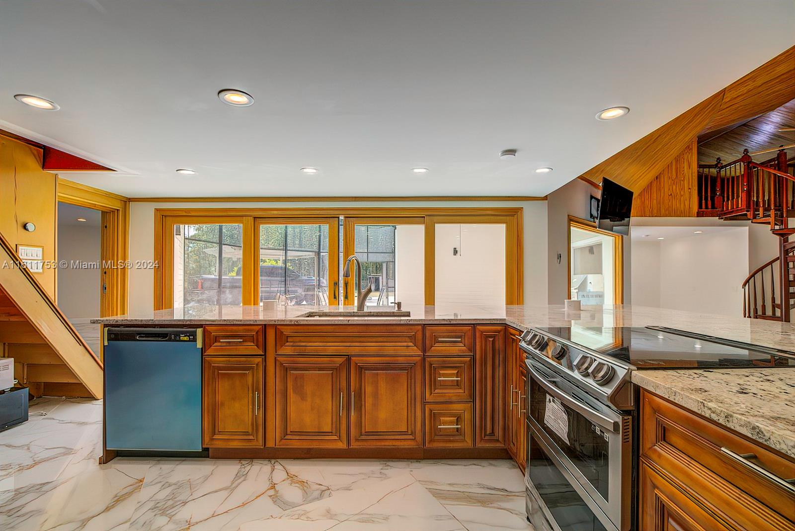 a kitchen with a sink stove and cabinets