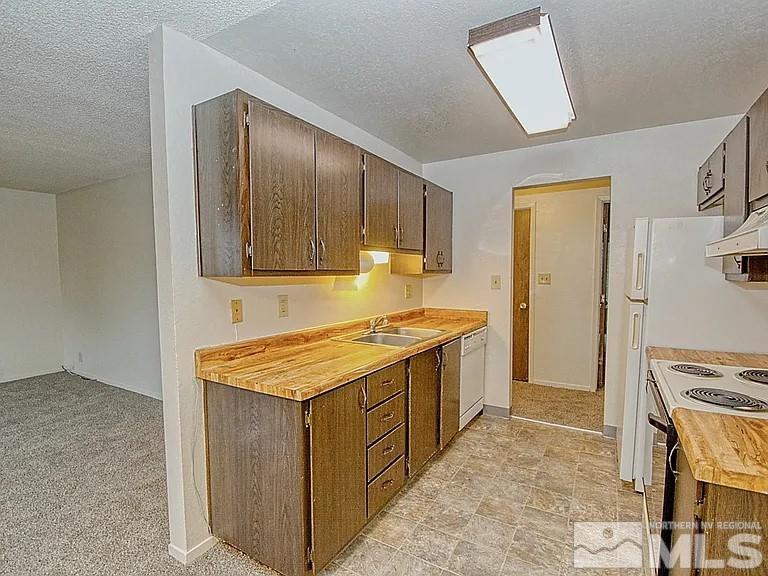 a kitchen with a stove and a refrigerator