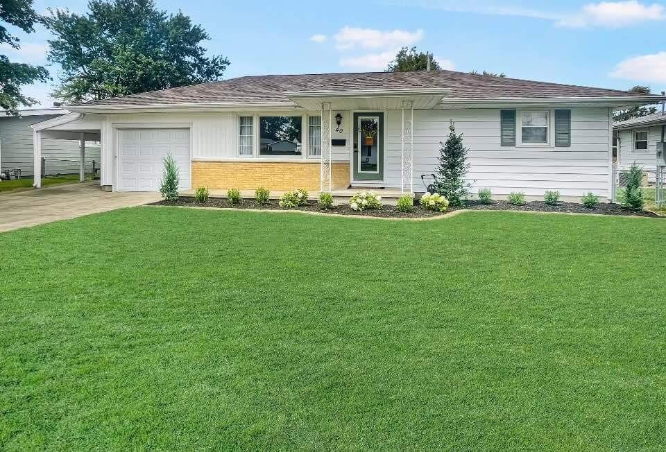 a front view of house with yard and green space