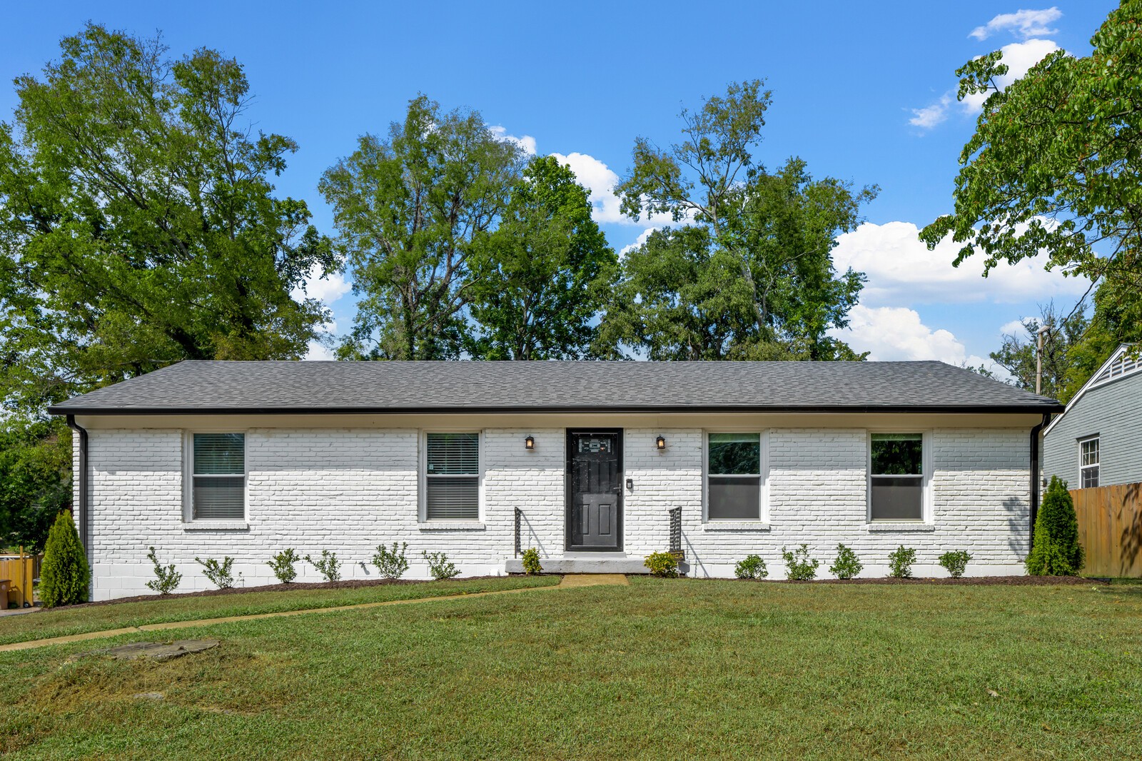 a front view of house with yard and green space